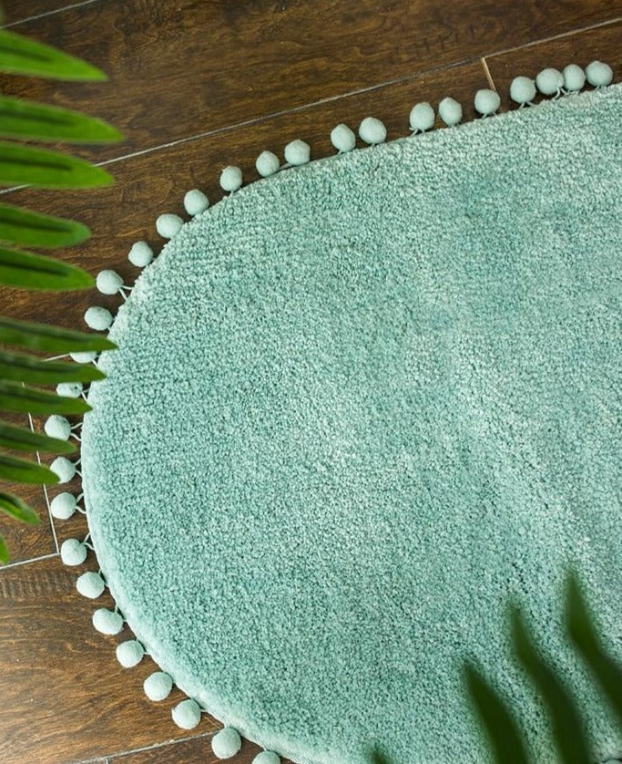 Tapis ovale antidérapant orné de pompons